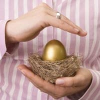 Woman protecting a golden egg in a nest