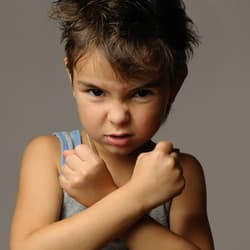 boy with arms crossed in front of him