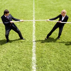 Man and woman playing tug-of-war