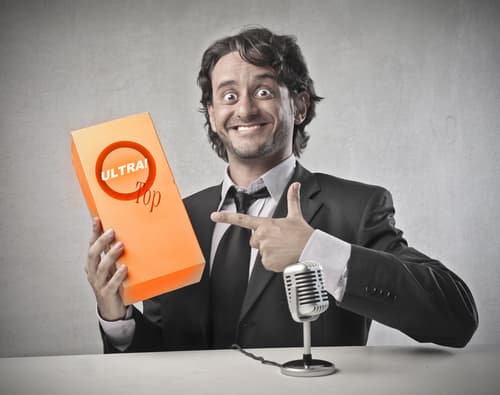 man holding brand in front of microphone