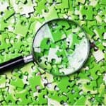 magnifying glass looking at puzzle pieces