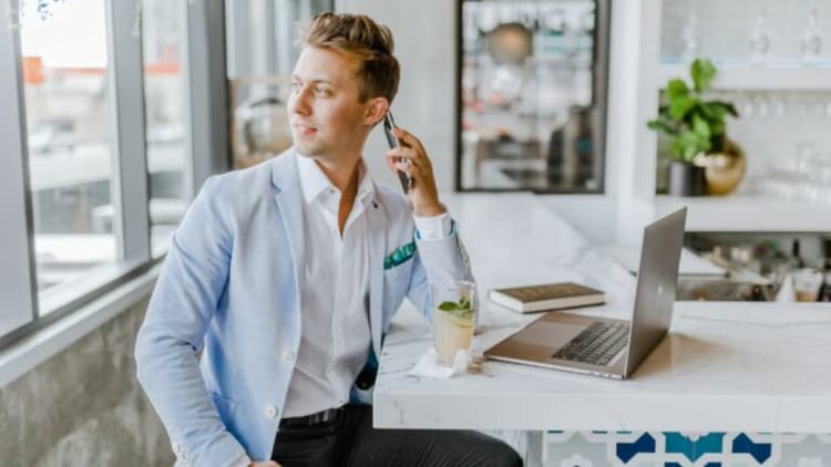 man sitting beside white wooden table