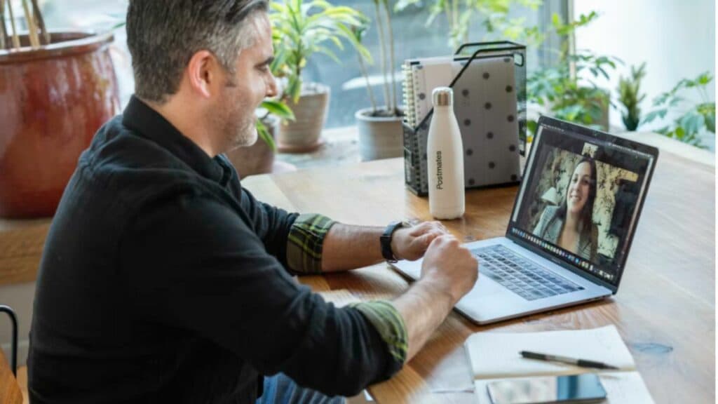 man in black sweater using macbook pro
