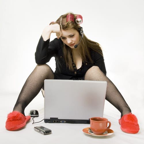 Woman in her slippers in front of the computer