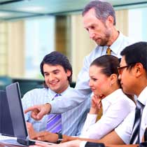 Boss and staff looking at computer screen