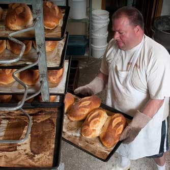 Small business owner baking fresh bread
