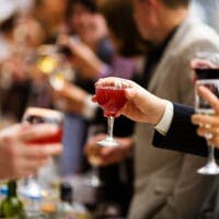 People drinking wine at an event