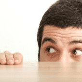 Man looking scared over table top