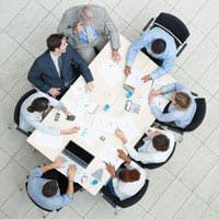 People sitting around a table, having a meeting