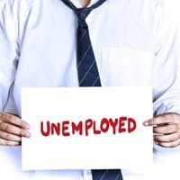 Man holding an unemployed sign