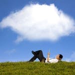 Man lying under a cloud on tablet