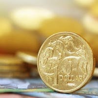 Australian one dollar coin standing on its edge