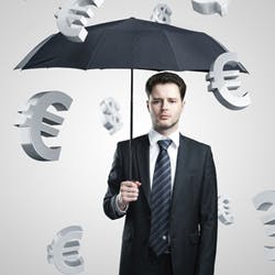 Man with an umbrella, as foreign currency signs fall around him