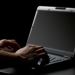 man typing on a computer