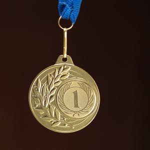 Gold medal on black background