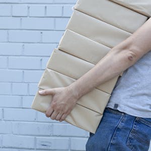 Man carrying pile of boxes
