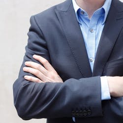business man with arms crossed in front of him