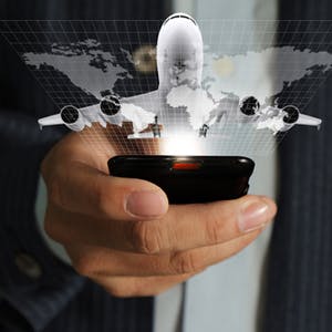 Businessman holding his mobile phone, with plane graphic above