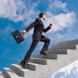 Businessman walking up a flight of stairs
