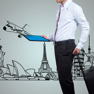 Business traveller holding a tablet and a suitcase