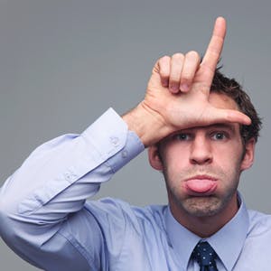 employee making a loser sign on his forehead