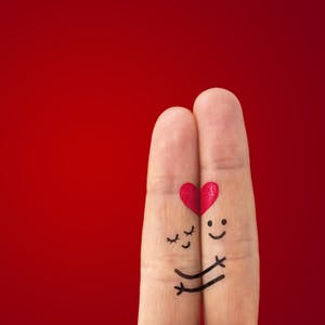 Two painted fingers representing a couple in love