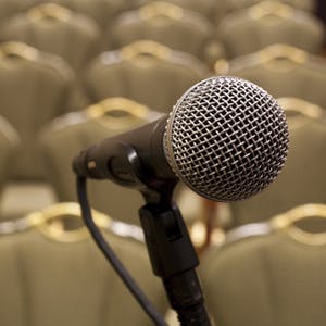 Microphone in front of rows of empty chairs