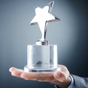 Award winner holding business trophy