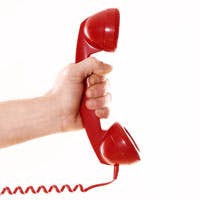 Hand holding out a red telephone handset