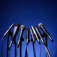 Stand of microphones on blue background