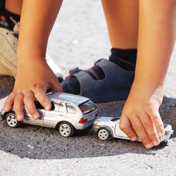 Child playing with toy cars