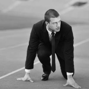 Business man, crouched at a race starting line