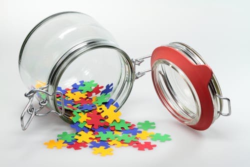 puzzle pieces coming out of a jar