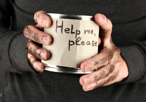 hands holding a charity tin