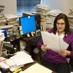 woman at cluttered desk
